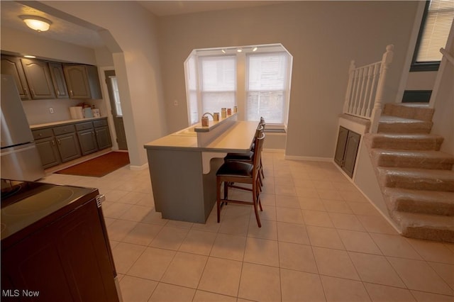 dining space featuring light tile patterned flooring and sink