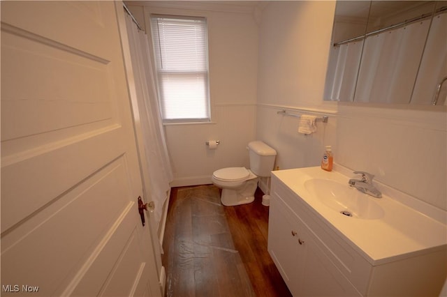 bathroom featuring wood-type flooring, toilet, and vanity