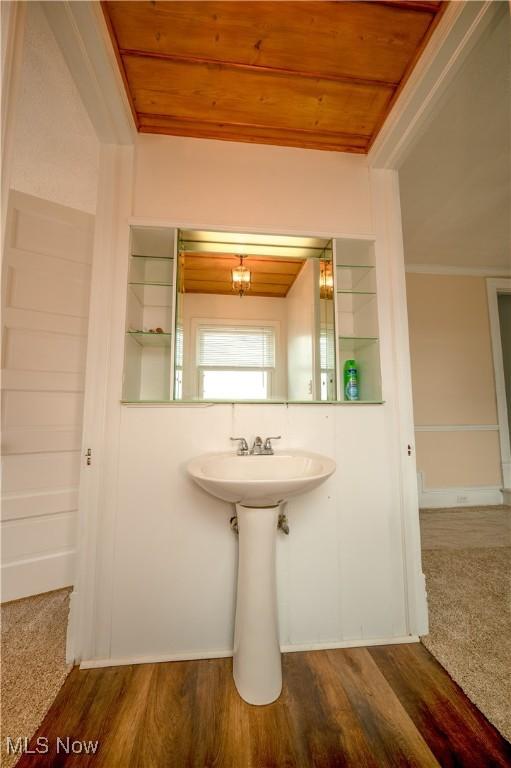 bathroom with hardwood / wood-style floors and wood ceiling