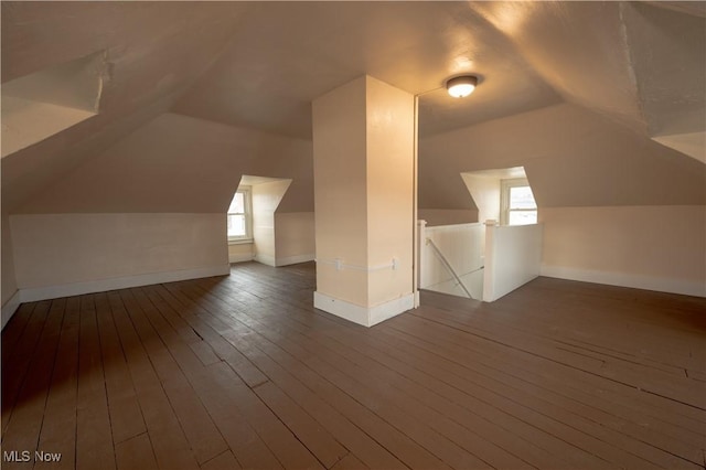 additional living space with lofted ceiling and dark wood-type flooring