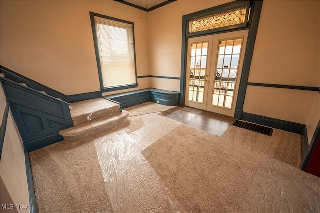 entryway with carpet floors and french doors