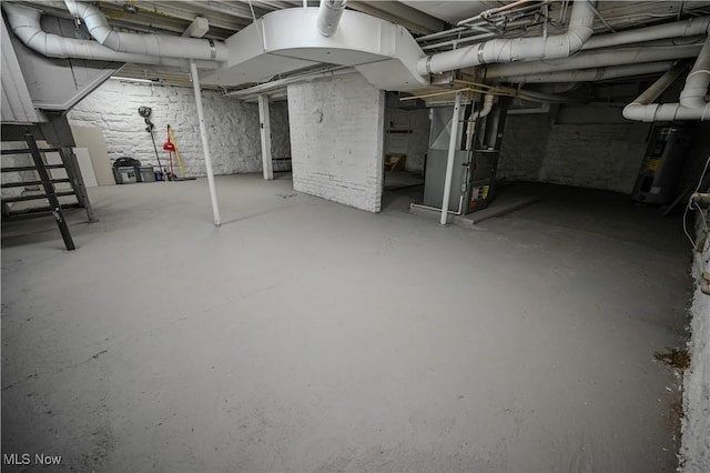 basement featuring water heater and heating unit