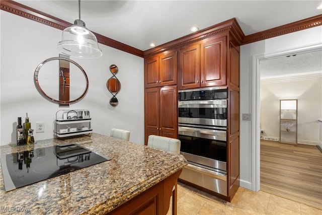 kitchen featuring decorative light fixtures, ornamental molding, black electric stovetop, light stone countertops, and stainless steel double oven