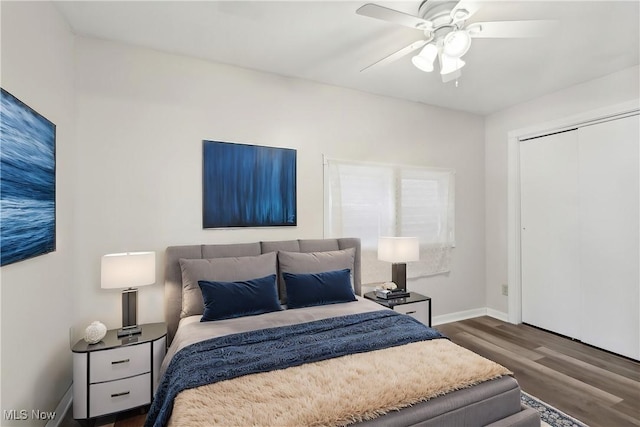 bedroom with baseboards, a closet, a ceiling fan, and dark wood-type flooring