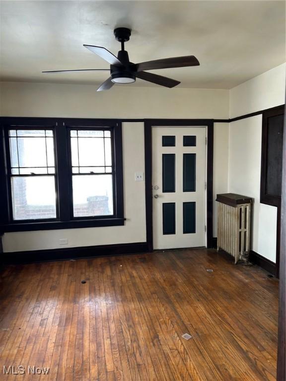 spare room featuring ceiling fan and dark hardwood / wood-style floors