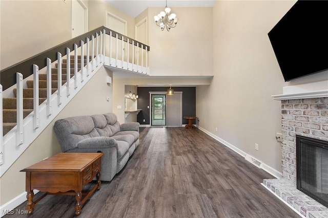 1260 Boardman-Canfield Rd # 29, Boardman, OH 44512 - living room featuring dark hardwood / wood-style floors, a chandelier, a fireplace, and a towering ceiling