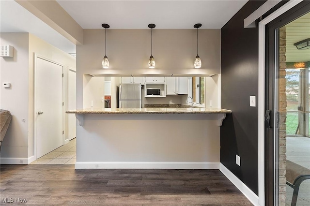 1260 Boardman-Canfield Rd # 29, Boardman, OH 44512 - kitchen with decorative light fixtures, stainless steel appliances, kitchen peninsula, and white cabinets