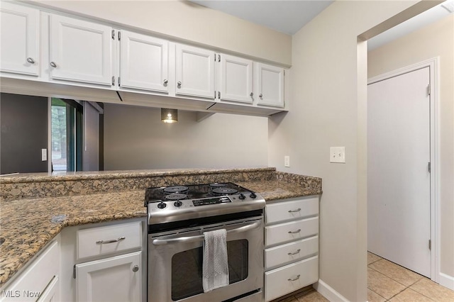 1260 Boardman-Canfield Rd # 29, Boardman, OH 44512 - kitchen with light tile patterned flooring, stainless steel range with electric stovetop, dark stone counters, and white cabinets