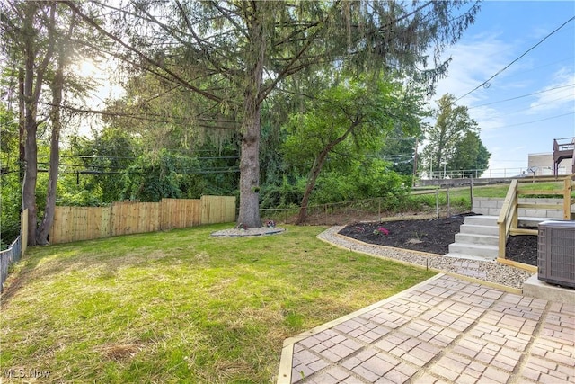 view of yard with cooling unit and a patio area