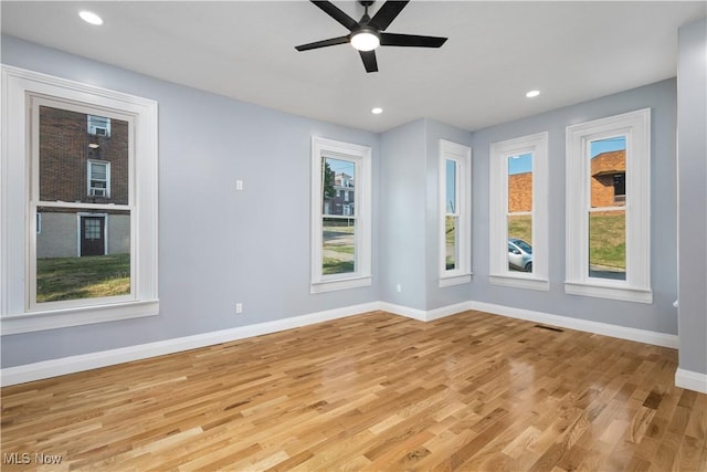 spare room featuring ceiling fan and light hardwood / wood-style floors