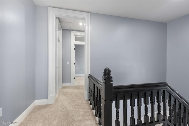 hallway with light colored carpet