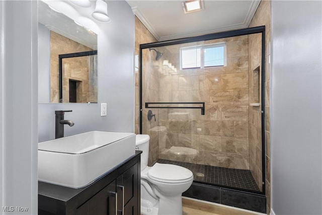 bathroom with ornamental molding, toilet, a shower with shower door, and vanity