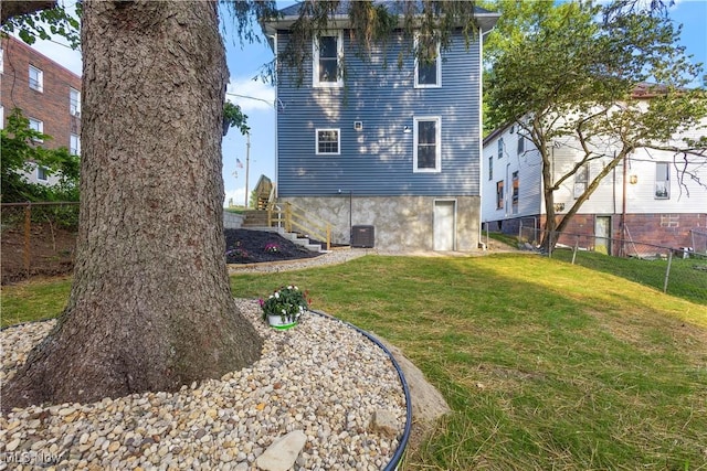 rear view of property featuring a yard