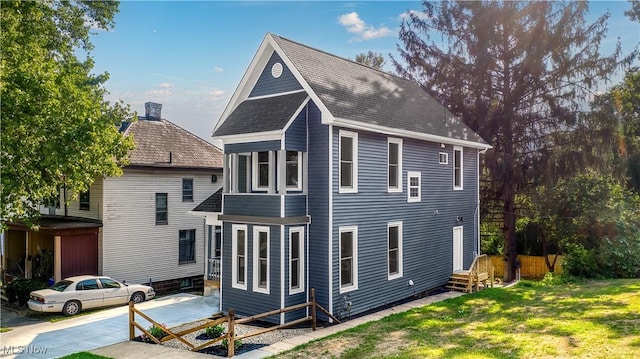 rear view of property with a yard