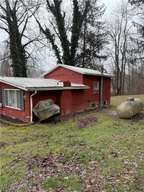 view of property exterior featuring a lawn