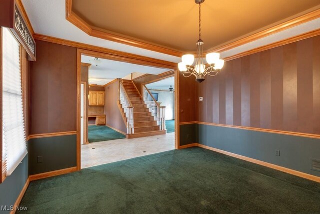 615 Crystal Brooke Dr, Hinckley, OH 44233 - empty room featuring a tray ceiling, stairway, a chandelier, carpet floors, and crown molding