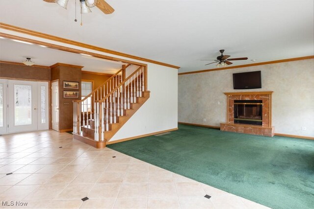 615 Crystal Brooke Dr, Hinckley, OH 44233 - unfurnished living room featuring ceiling fan, baseboards, ornamental molding, stairway, and a premium fireplace