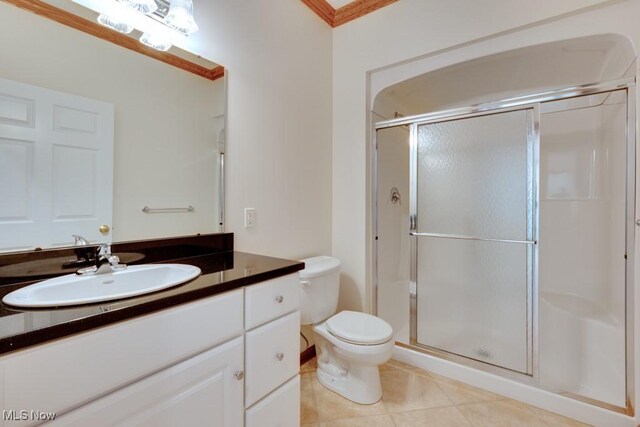 615 Crystal Brooke Dr, Hinckley, OH 44233 - bathroom featuring a stall shower, toilet, vanity, tile patterned floors, and ornamental molding