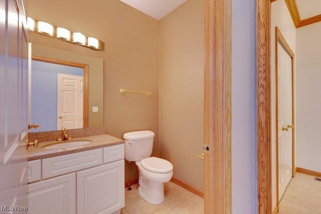 615 Crystal Brooke Dr, Hinckley, OH 44233 - bathroom with toilet, vanity, tile patterned flooring, and baseboards