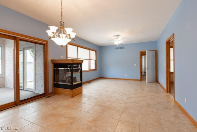 615 Crystal Brooke Dr, Hinckley, OH 44233 - unfurnished living room with baseboards, a ceiling fan, a multi sided fireplace, light tile patterned floors, and a chandelier