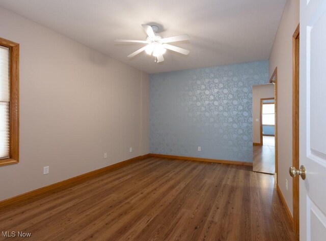 615 Crystal Brooke Dr, Hinckley, OH 44233 - unfurnished room with ceiling fan, wood finished floors, baseboards, and wallpapered walls