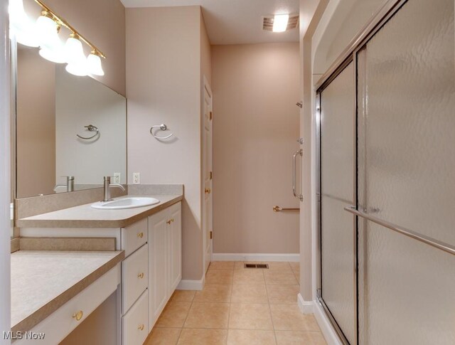 615 Crystal Brooke Dr, Hinckley, OH 44233 - full bathroom featuring a stall shower, tile patterned flooring, vanity, and baseboards