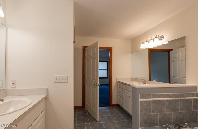 615 Crystal Brooke Dr, Hinckley, OH 44233 - bathroom featuring two vanities, tile patterned flooring, and baseboards