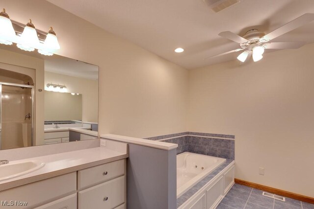 615 Crystal Brooke Dr, Hinckley, OH 44233 - full bathroom featuring a shower stall, tile patterned floors, a tub with jets, vanity, and a ceiling fan