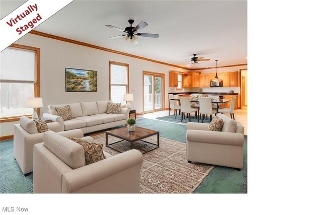 615 Crystal Brooke Dr, Hinckley, OH 44233 - living area featuring light colored carpet, a ceiling fan, crown molding, and baseboards