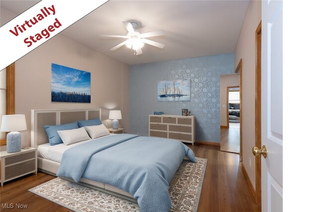 615 Crystal Brooke Dr, Hinckley, OH 44233 - bedroom with wallpapered walls, wood finished floors, baseboards, an accent wall, and a ceiling fan