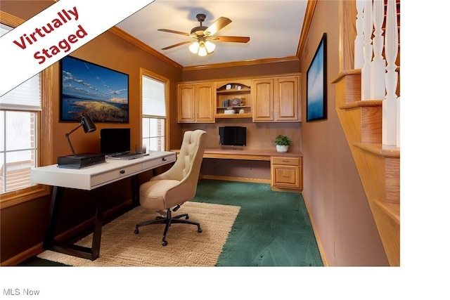 615 Crystal Brooke Dr, Hinckley, OH 44233 - office area with dark carpet, crown molding, built in study area, ceiling fan, and baseboards