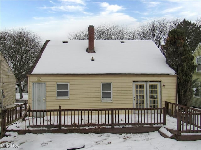 view of snow covered back of property