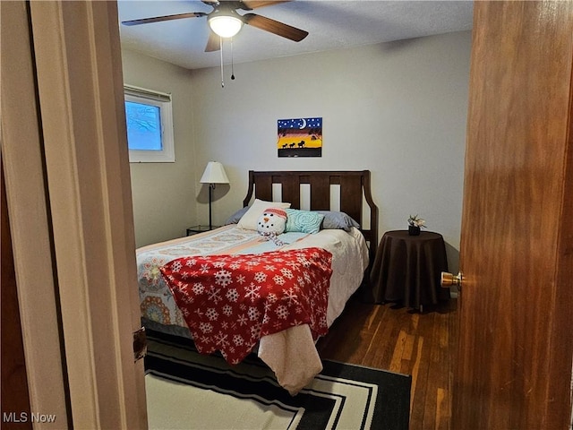 bedroom with dark wood-type flooring and ceiling fan