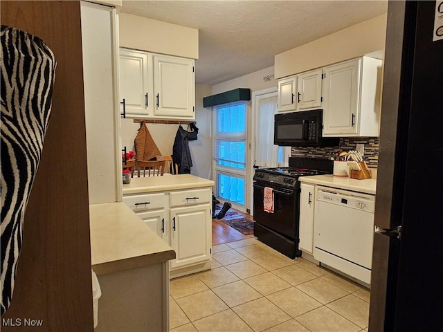 kitchen featuring white cabinetry, a textured ceiling, light tile patterned floors, decorative backsplash, and black appliances