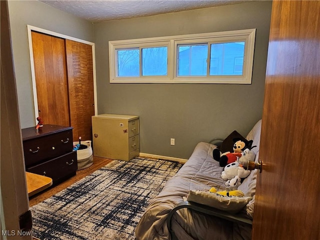 bedroom featuring a textured ceiling and a closet