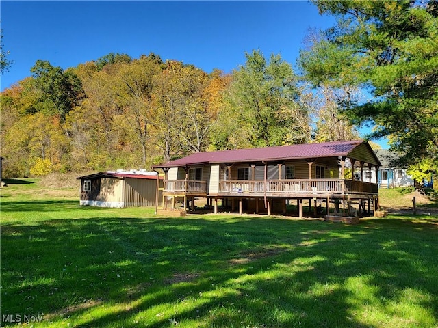 rear view of house featuring a yard