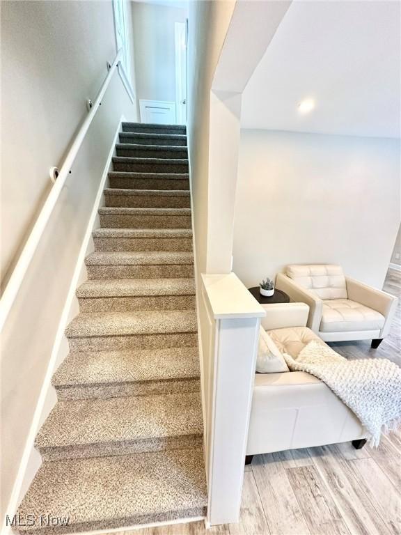 stairs featuring wood-type flooring