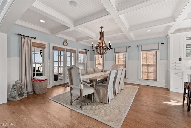 dining space featuring beamed ceiling, coffered ceiling, french doors, and light hardwood / wood-style flooring