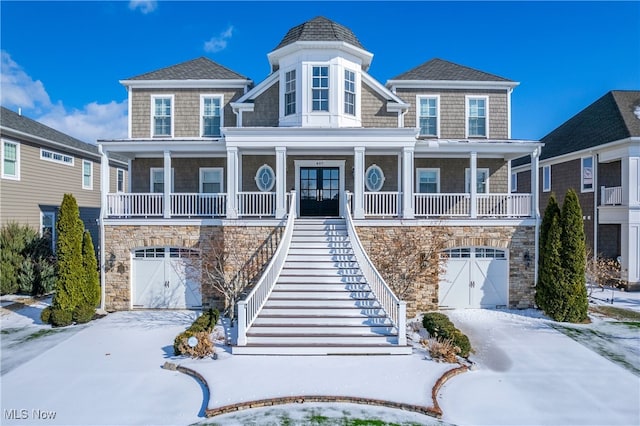 view of front facade with a garage and covered porch