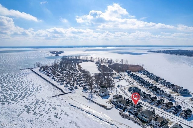 snowy aerial view featuring a water view