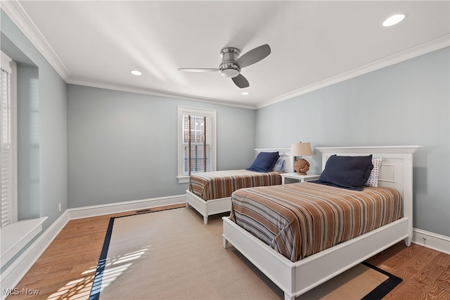 bedroom with wood-type flooring, ornamental molding, and ceiling fan