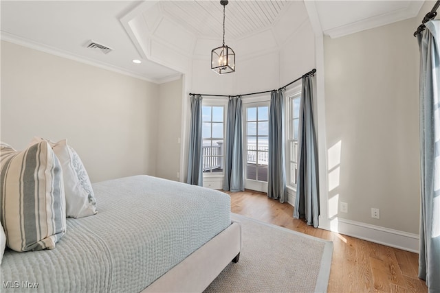 bedroom with crown molding, access to exterior, an inviting chandelier, and light hardwood / wood-style flooring