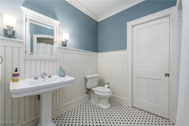 bathroom with crown molding and toilet