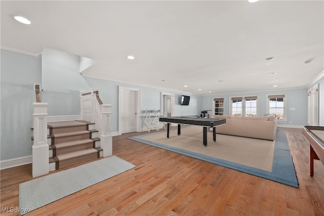 playroom with crown molding and light hardwood / wood-style flooring