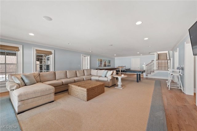 living room featuring crown molding and light wood-type flooring