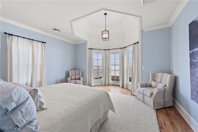 bedroom featuring an inviting chandelier, ornamental molding, access to exterior, and hardwood / wood-style floors