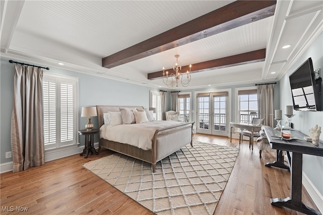 bedroom featuring beamed ceiling, an inviting chandelier, light hardwood / wood-style floors, and multiple windows