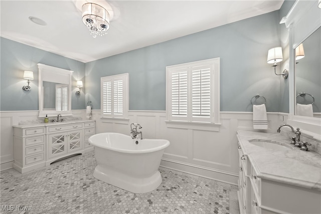 bathroom featuring vanity, a bathtub, and tile patterned floors