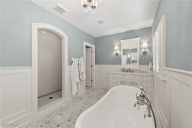 bathroom featuring vanity, tile patterned flooring, and plus walk in shower