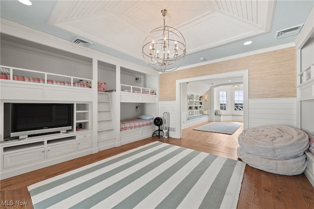 bedroom with crown molding, dark wood-type flooring, and a notable chandelier